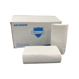 Stacks of white multi-fold towels in front of their box.